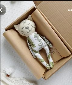 an open box with a stuffed animal in it