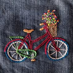 a red bicycle with a basket full of flowers on it