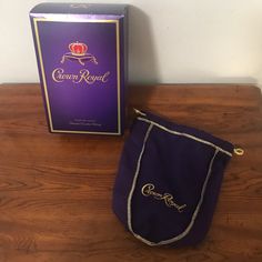 a purple bag sitting on top of a wooden table next to a box with the name crown royal