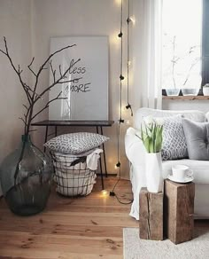 a living room with a white couch and some lights on the wall next to it