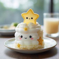 there is a small cupcake on the plate with a star on top and eyes drawn on it