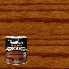 a can of wood stain sitting on top of a wooden table