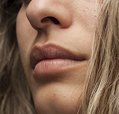 a close up of a woman's face with long blonde hair