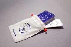 two small bags sitting on top of a table next to each other, one with an orange string