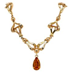 This exquisite vintage necklace exudes a timeless, feminine glamour that harkens back to the retro styles of the 1940s. Finely crafted in luxurious 18k yellow gold, it showcases a warm, rosy tone characteristic of antique gold pieces from that era. The necklace measures 17 inches in length and weighs approximately 19 grams, blending delicacy with meaningful weight and presence. The necklace's front is adorned with an ornate series of fancy articulated links, forming an alluring garland-like patt 1940s Necklace, Spessartite Garnet, Retro Styles, Delicate Details, Retro Stil, Vibrant Orange, Style Retro, Necklace Designs, Vintage Stil