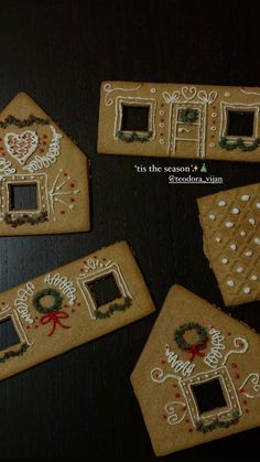 four decorated gingerbread houses on a table