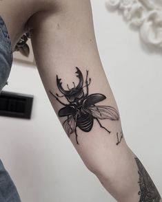 a black and white photo of a bee on the arm