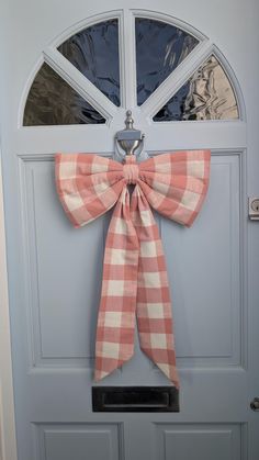 a bow hangs on the front door of a house