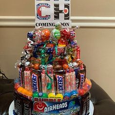 a birthday cake made to look like a candy tower with lots of candies on top