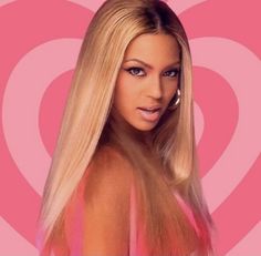 a woman with long blonde hair standing in front of a heart shaped pink wallpaper