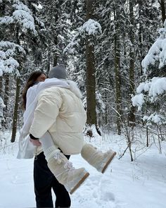 a woman carrying a child through the snow