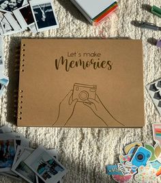 a notebook with the words let's make memories written on it surrounded by photos and magnets