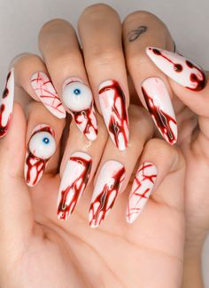 Get ready to make a statement with these spooky and bold Horror Eyes Gothic Long Almond Press on Nails! Perfect for Halloween, cosplay, or any event where you want to showcase your dark and edgy side, these hand-painted fake nails are designed to turn heads. Featuring a unique bloody eye design with splattered red accents, these nails are ideal for those looking to add a creepy, artistic touch to their look. 🐰Sizing Guide: XS/S/M/L XS: 14-10-11-10-8 (mm) S: 15-11-12-11-9 (mm) M: 16-12-13-12-10 (mm) L: 17-13-14-13-11 (mm) 🐰 What's Included in Your Press on Nail Kit? * 10 nails of your size  * 24 adhesive tabs  * 1 mini nail file * 1 cuticle stick  * 1 alcohol pad   * Instruction on how to apply and remove them 🐰 Benefits of Our Press on Nails: ✨ Easy Application & Removal: Perfect for sp Halloween Gothic Nails, Halloween Makeup Unique, Carnival Nails, Nail Halloween, Long Almond, Gothic Emo, Gothic Nails, Fake Nail, Fabulous Nails