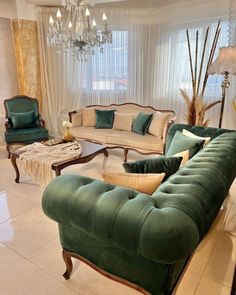 a living room filled with furniture and a chandelier