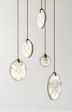 three circular glass pendants hanging from the ceiling