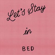 the words let's stay in bed are written on pink paper with black ink