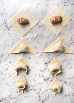 four different types of food on top of some paper napkins and one has meatballs in the middle