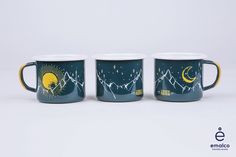 three coffee mugs with mountains, stars and the moon painted on them are sitting side by side