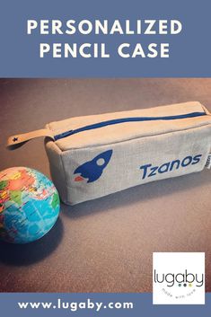 the personalized pencil case is next to an earth globe