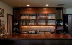 a wooden counter topped with lots of records