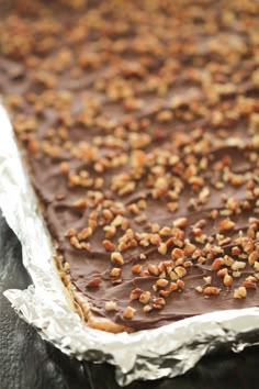 there is a chocolate cake with nuts on top in the baking pan, ready to be eaten