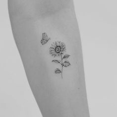 a small sunflower and butterfly tattoo on the ankle