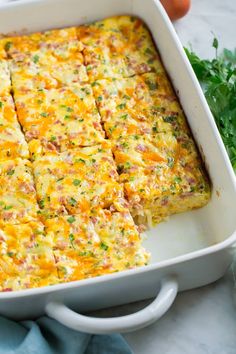 breakfast casserole with ham and cheese in a white baking dish