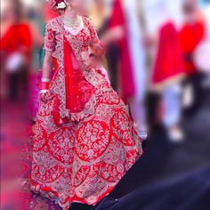 a woman in a red and white wedding dress