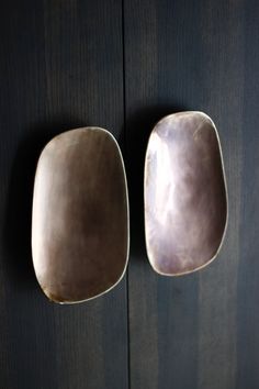 two square shaped dishes hanging on the wall