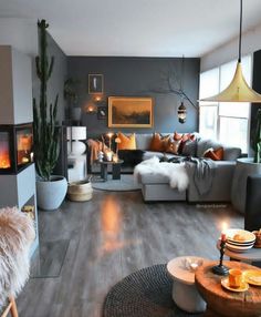 a living room filled with lots of furniture next to a fire place and potted plant