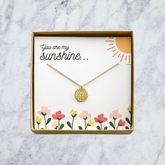 "A super cute \"you are my sunshine\" sun charm pendant necklace. This adorable sun necklace makes the perfect gift for any girl, any age! You'll love the look of excitement in their eye as they open their very own piece of trendy jewelry! D E T A I L S -\"You are my Sunshine\" Sun Girl's Necklace -1/2\" gold plated sun pendant -Chain length: choose your color & chain length from drop down menu -The perfect gift for your daughter or other special little one! V I E W - O U R - O T H E R - N E C K Adjustable Inspirational Charm Necklace For Gift, Inspirational Adjustable Charm Necklaces As Gift, Adjustable Inspirational Charm Necklaces As Gift, Adjustable Inspirational Charm Necklace As A Gift, Inspirational Adjustable Necklace For Birthday Gift, Sun-shaped Jewelry With Sun And Moon Design For Gift, Dainty Sun And Moon Charm Necklace For Gift, Dainty Sun And Moon Charm Necklace Gift, Dainty Sun And Moon Charm Necklaces As A Gift