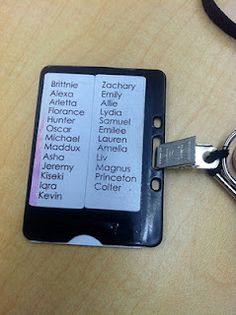 a keychain that is attached to a cell phone with the names of people on it