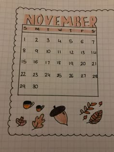 a november calendar with leaves and acorns drawn on the sheet in front of it