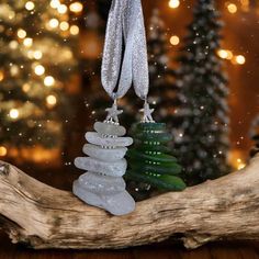 a christmas tree ornament hanging from a branch