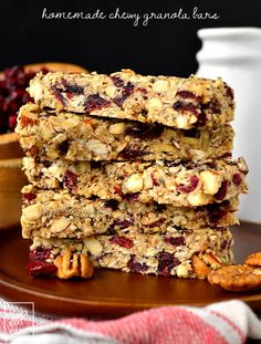 three granola bars stacked on top of each other with nuts and cranberries