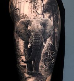 an elephant is walking through the woods with trees on his shoulder and behind him are palm trees