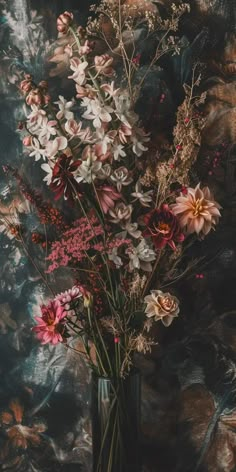 a vase filled with lots of flowers sitting on top of a table next to a wall