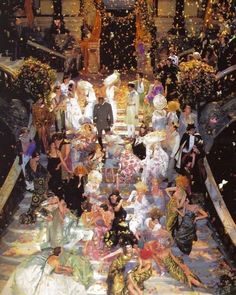 a large group of people standing on top of a boat filled with confetti