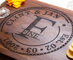 personalized cutting board with cheese and crackers on the side for guests to eat