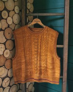 an old sweater hanging on a wooden ladder