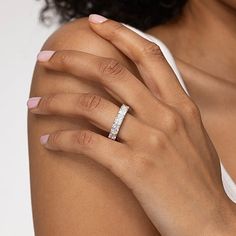 a woman's hand with a diamond ring on her left wrist and right arm