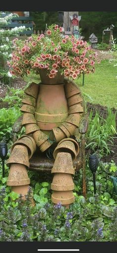 a large potted planter sitting on top of a wooden bench in a garden