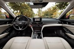 the interior of a car with dashboard, steering wheel and center console view from inside