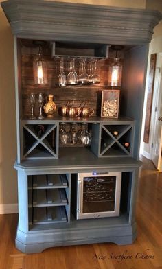 a kitchen hutch with wine glasses on the shelves