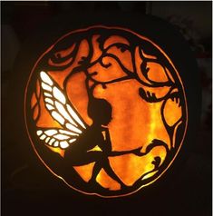 a carved glass window with a fairy on it's side and a silhouette of a child