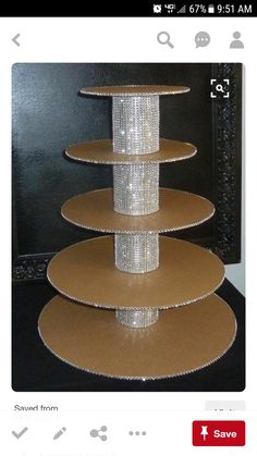 three tiered cake stand in front of a black wall with a mirror behind it