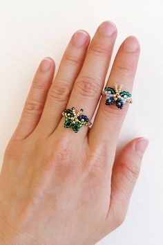 a woman's hand with two rings on it