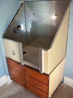 a large metal cabinet with drawers in the corner and a paw print on the door