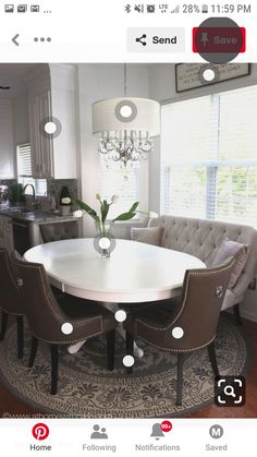 a dining room table with chairs around it and a chandelier hanging from the ceiling