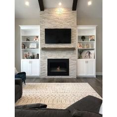 a living room with a fireplace and entertainment center